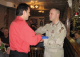 Minnesota Army National Guard Captain Aaron Krenz, a native of Wheaton, presents the Minnesota flag ...