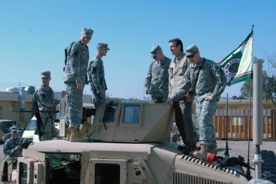 Governor Pawlenty examines a Humvee belonging to members of the Minnesota National Guard during a st...