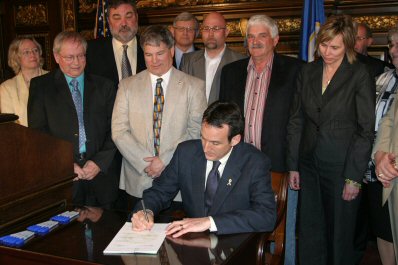 Governor Pawlenty signs H.F. 4075, legislation that provides funding and control measures for the er...