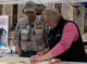 Lieutenant Governor Molnau participates in a walleye filleting and cooking demonstration with the Mi...