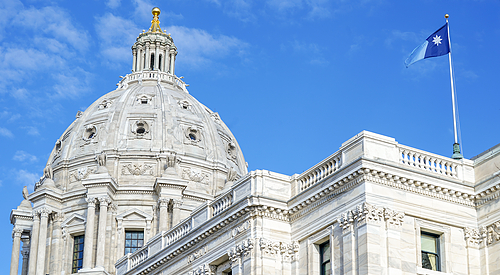 MN state capitol dome with state flag